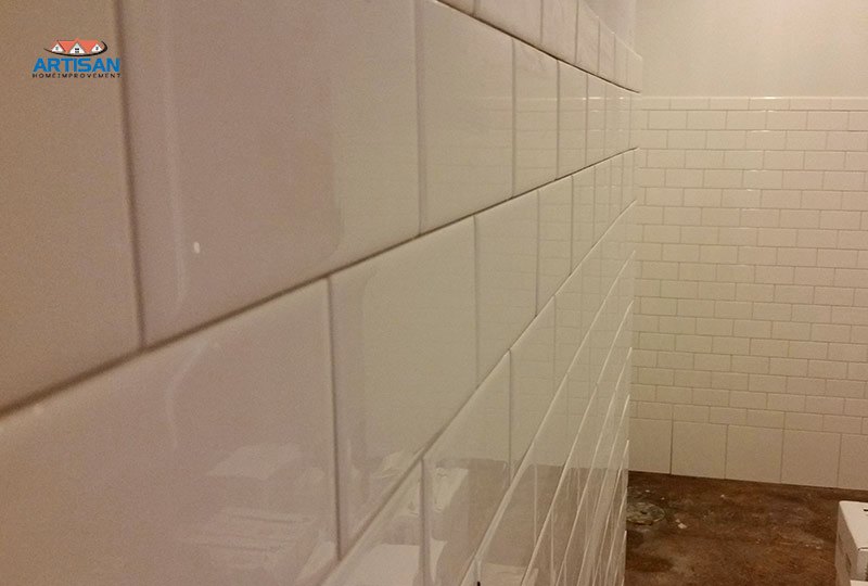 A subway tiled shower wall during installation