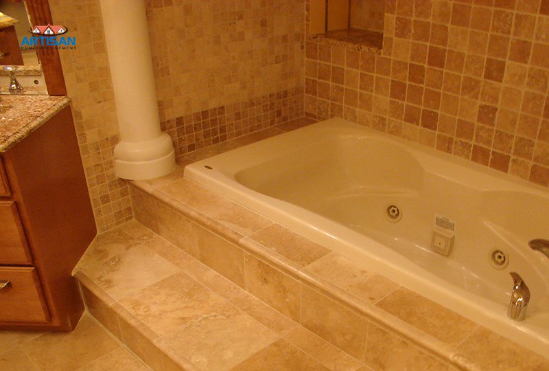 A stone tub deck and surround with a column detail