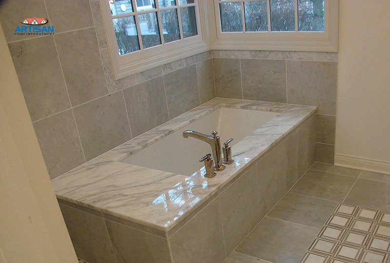A marble tub surround and stone floor